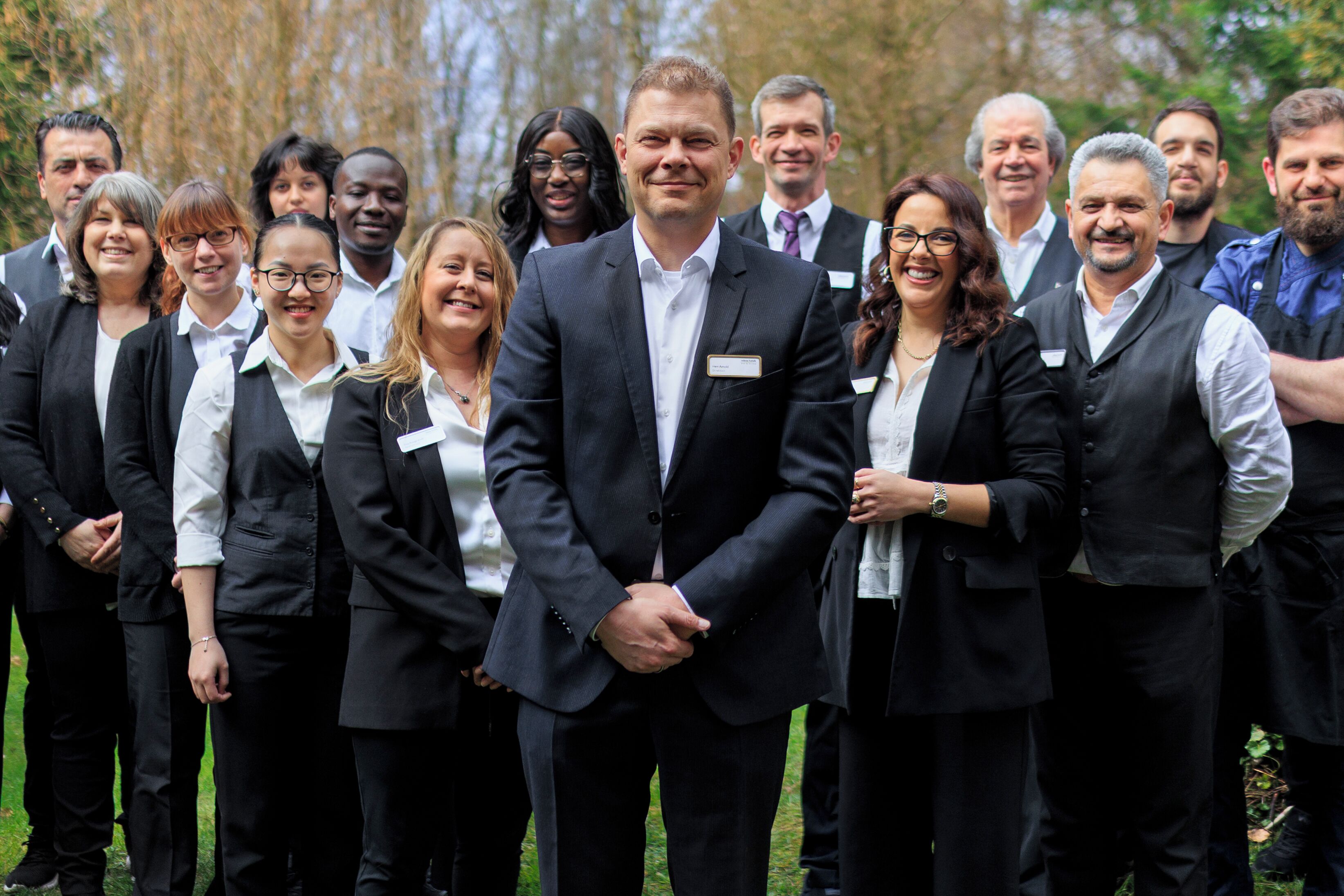 A group of people in business attire standing outdoors.