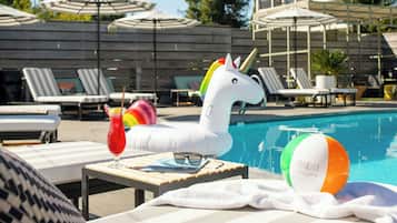 Relax by the pool with lounge chairs, a unicorn float, and a beach ball at your fingertips.