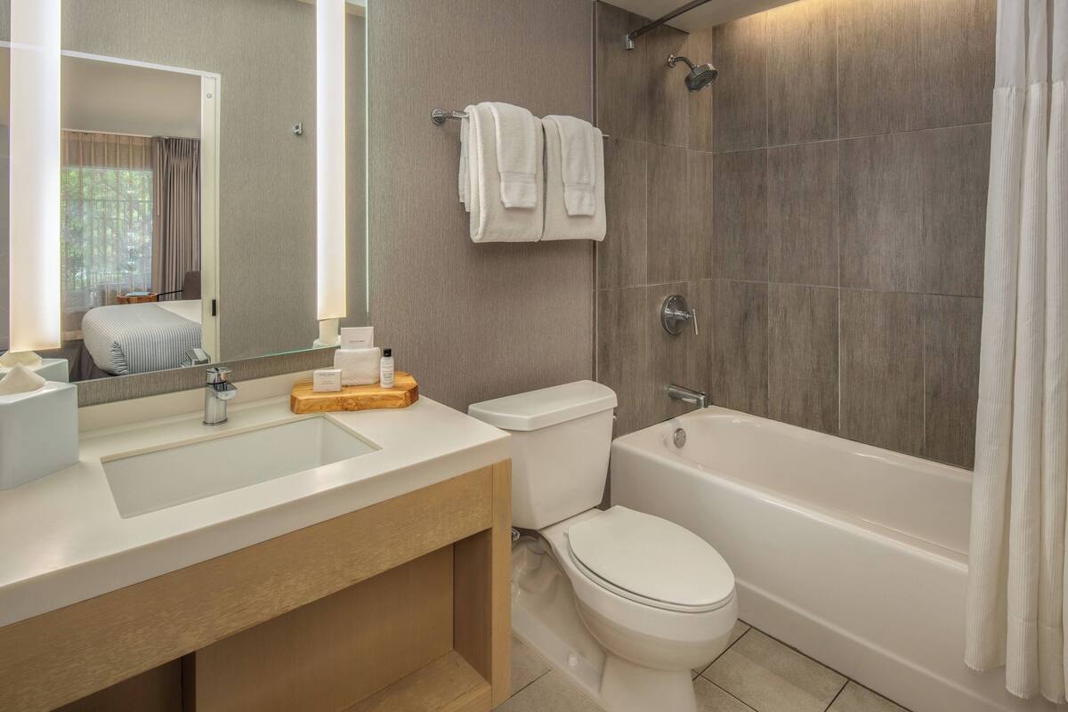 deep-soaking bathtub, rainfall showerhead, designer toiletries