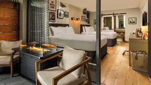 A hotel room with a bed, a seating area with a table, a desk, and a mirror. - Hotel Paradox, Autograph Collection (Santa Cruz)