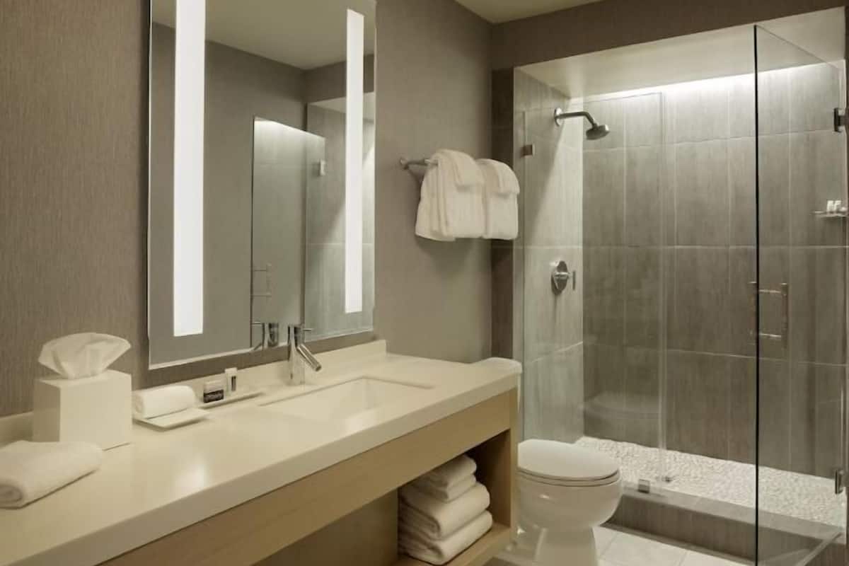 Deep-soaking bathtub, rainfall showerhead, designer toiletries
