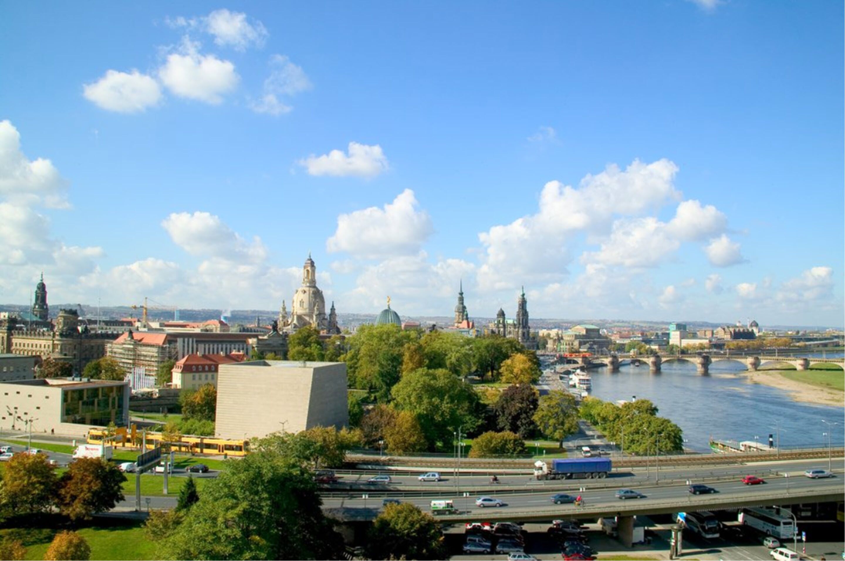 A cityscape with a river, bridges, and historic buildings.
