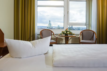 Premium bedding, desk, laptop workspace, blackout drapes. Hotel Am Terrassenufer