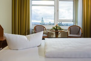 Premium bedding, desk, laptop workspace, blackout drapes