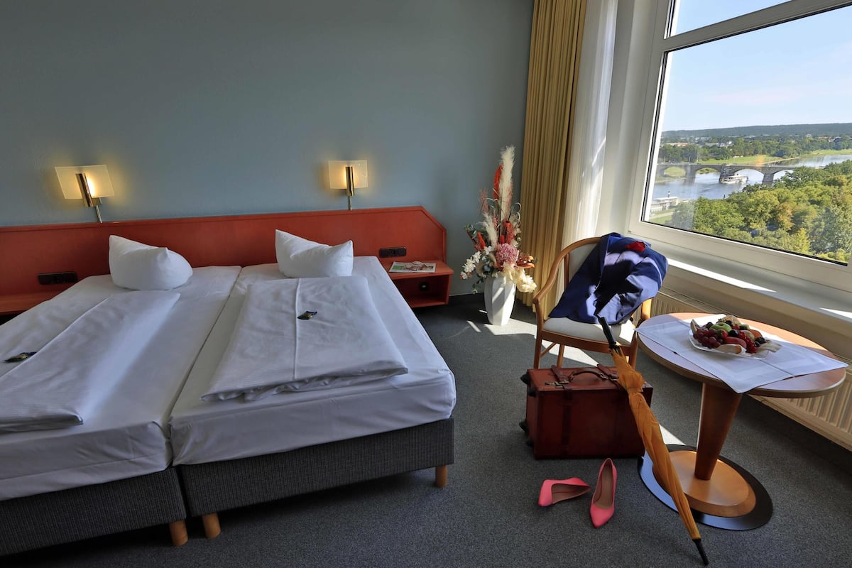 Premium bedding, desk, laptop workspace, blackout drapes