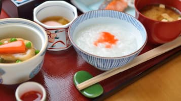 A tray with various dishes including a bowl of rice, a bowl of soup, and a dish with vegetables and meat.