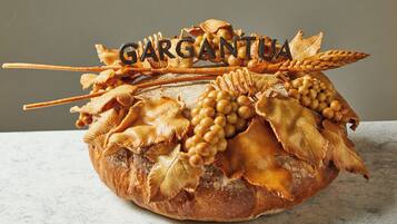 A loaf of bread with decorative toppings and the word "GARGANTUA" on top.