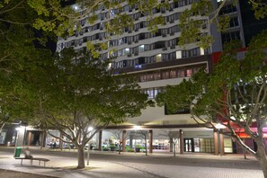 A hotel with multiple floors, outdoor seating, and a tree-lined walkway. - Capetonian Hotel (Cape Town)