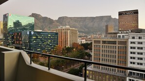 A cityscape with modern buildings, including a recognizable ABSA building, and a mountain in the background. - Capetonian Hotel (Cape Town)