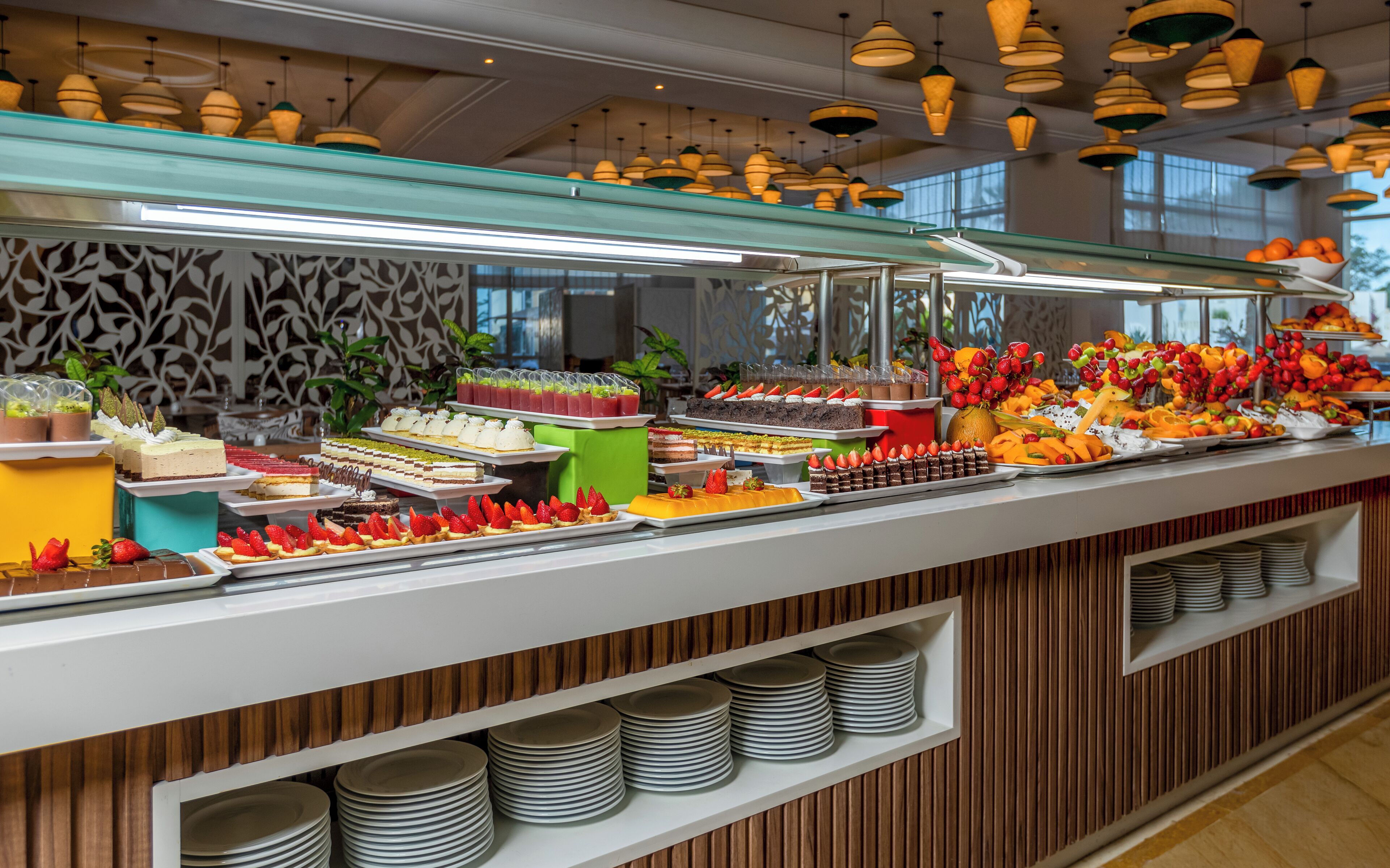 A buffet with various food items and a glass display case.