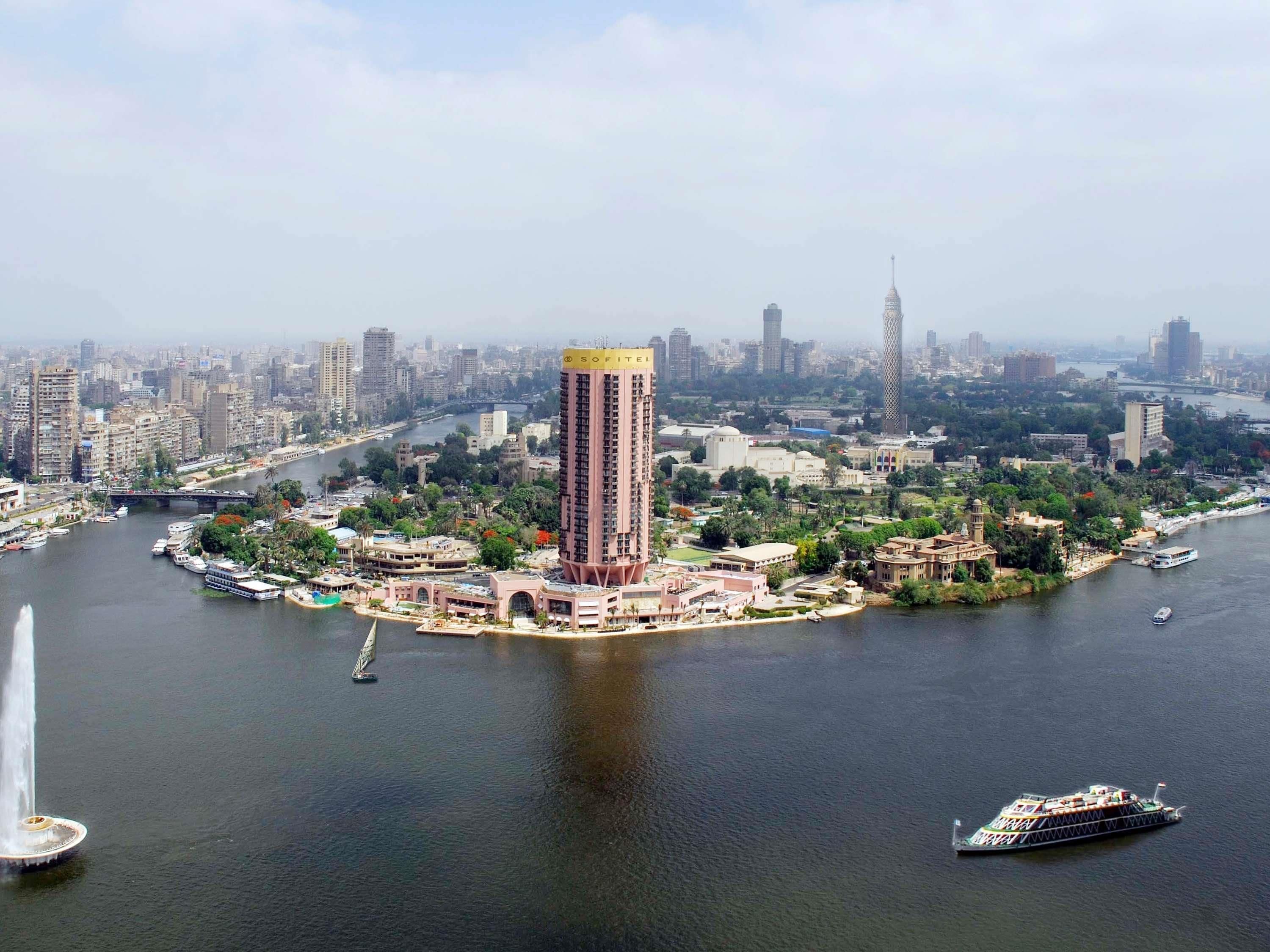A high-rise building with a prominent sign labeled "SOFIEL" in the center of a cityscape.