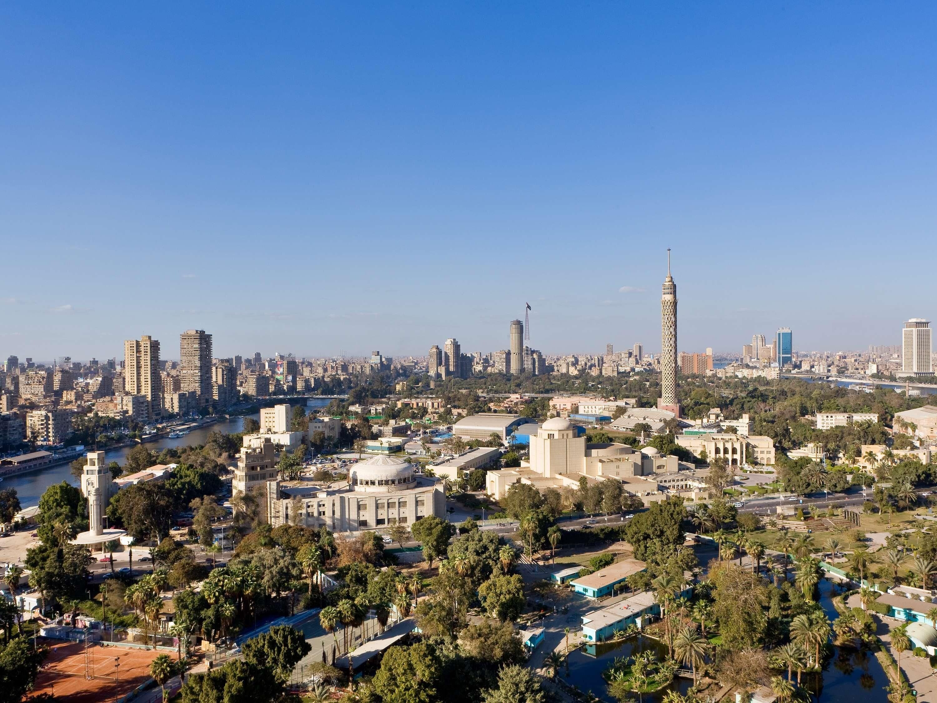 A cityscape with a prominent tower, dense urban buildings, and a river.