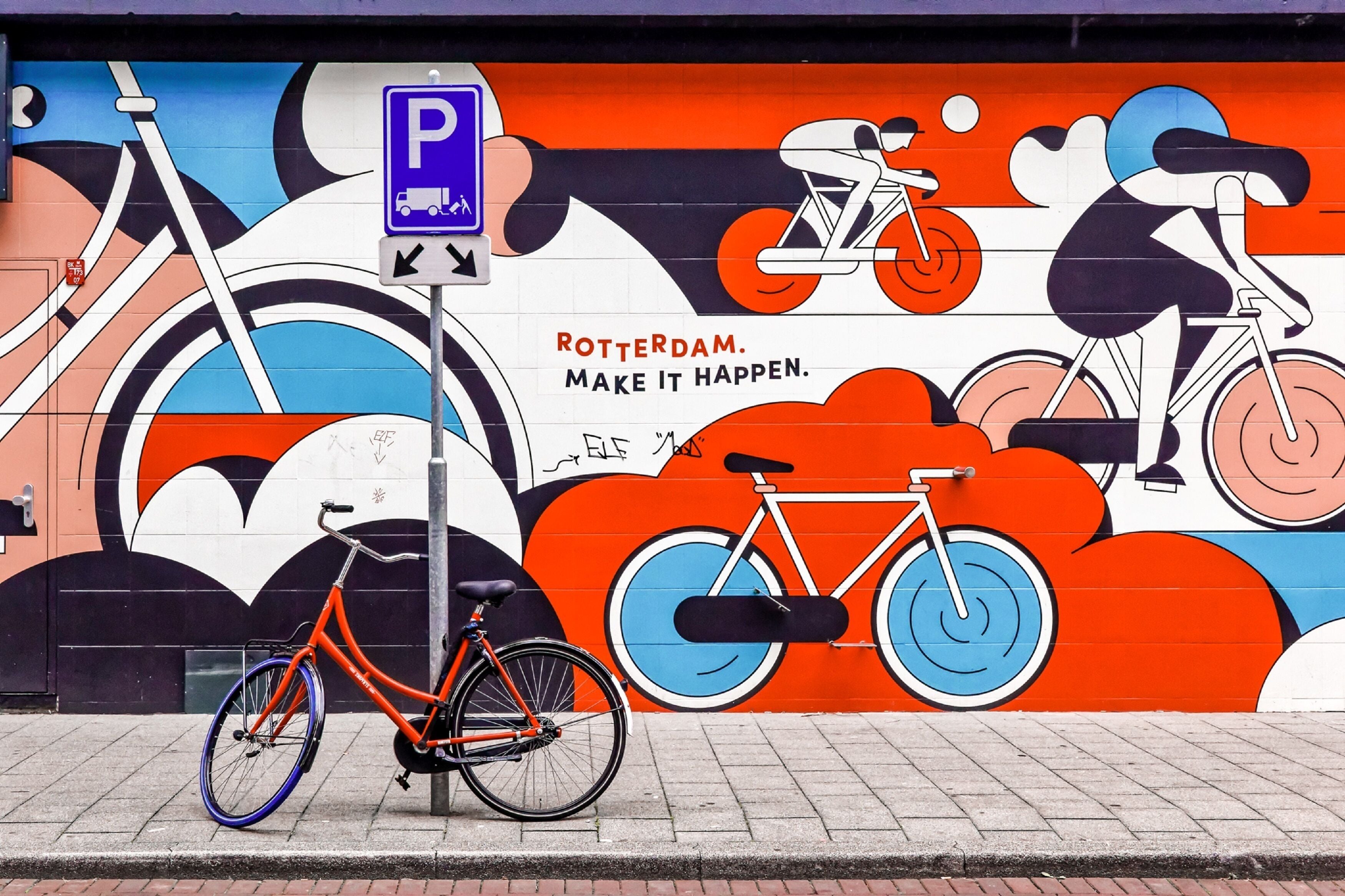 A mural with bicycles and a parking sign.