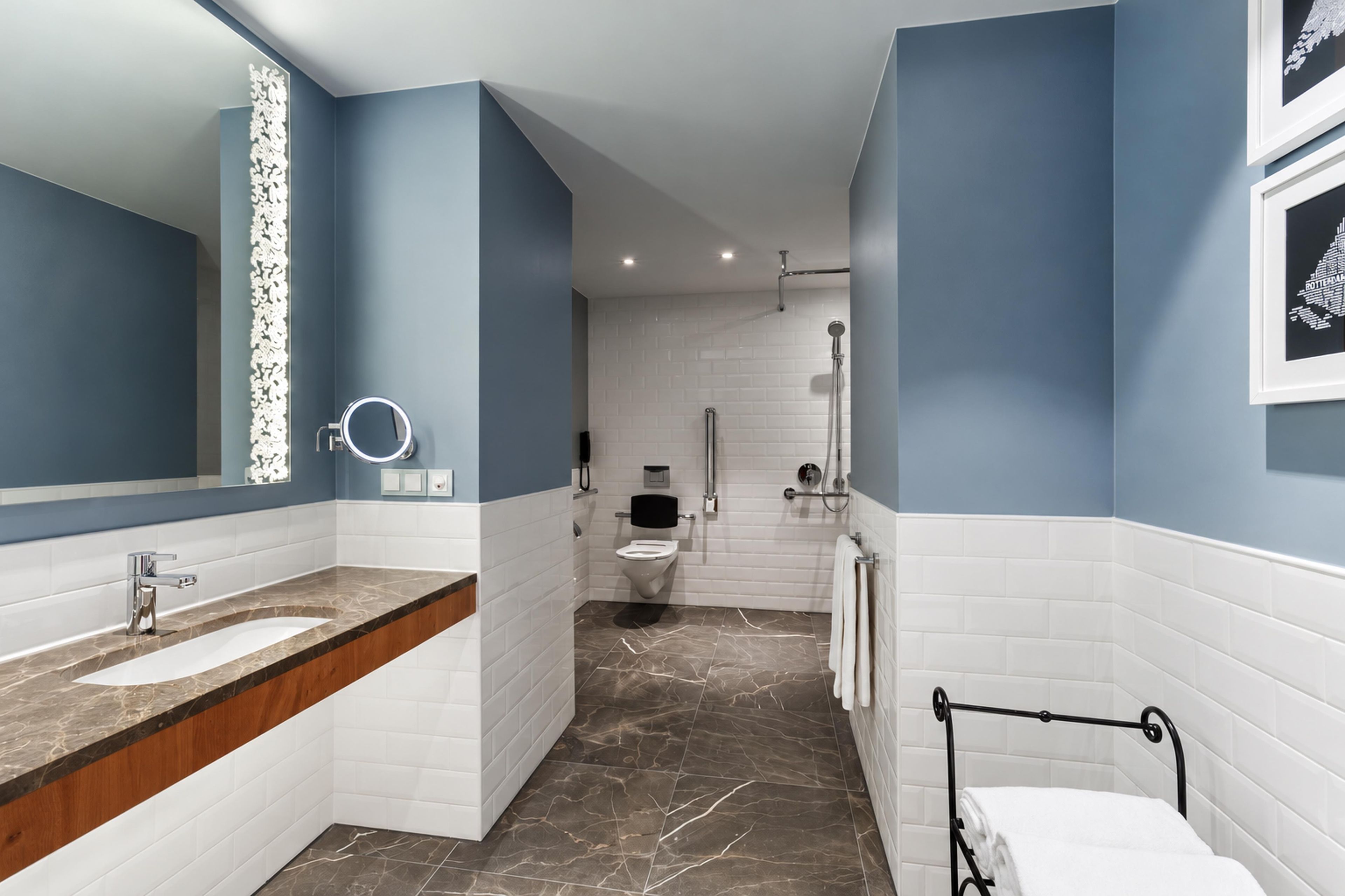 A modern bathroom with a vanity, a toilet, and a shower area.