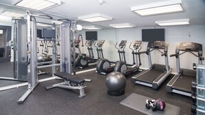 A gym with exercise equipment, treadmills, and a weightlifting area. - Hotel Ziggy on Sunset (West Hollywood)