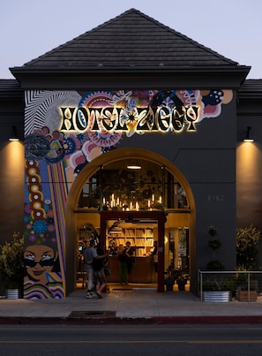 A building with a large illuminated sign reading 'HOTEL ZIGZAG.' - Hotel Ziggy on Sunset (West Hollywood)