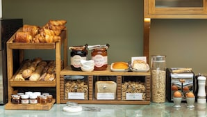 A bakery display with various breads, pastries, and spreads. - Hotel Casimir (Paris)