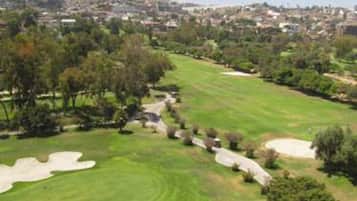 Enjoy a serene round of golf amidst lush trees and manicured fairways.