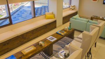 A modern living room with a long wooden bench, a sofa, and a coffee table.