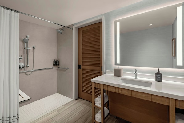 Un baño moderno con ducha, inodoro y lavamanos.