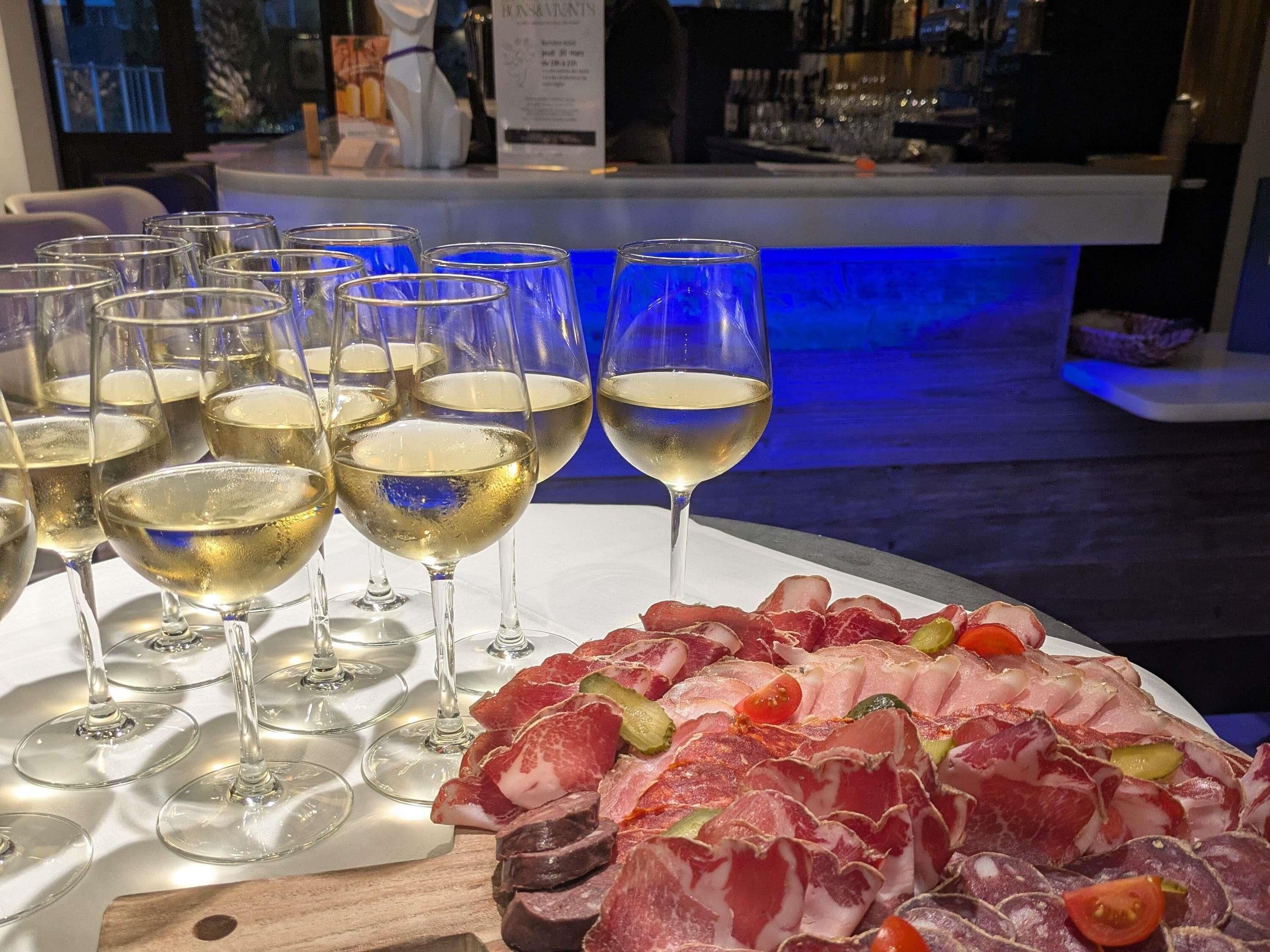 A table with multiple wine glasses and a charcuterie board.