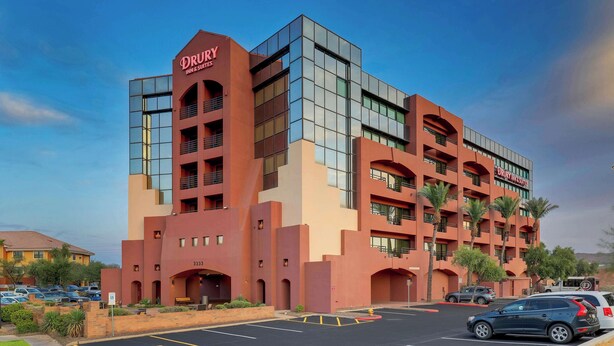 A multi-story hotel with a prominent red facade and a modern glass section. - Drury Inn & Suites Phoenix Airport (Phoenix)