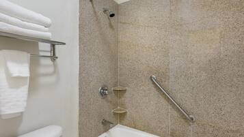 A bathroom with a shower, a toilet, and a towel rack.
