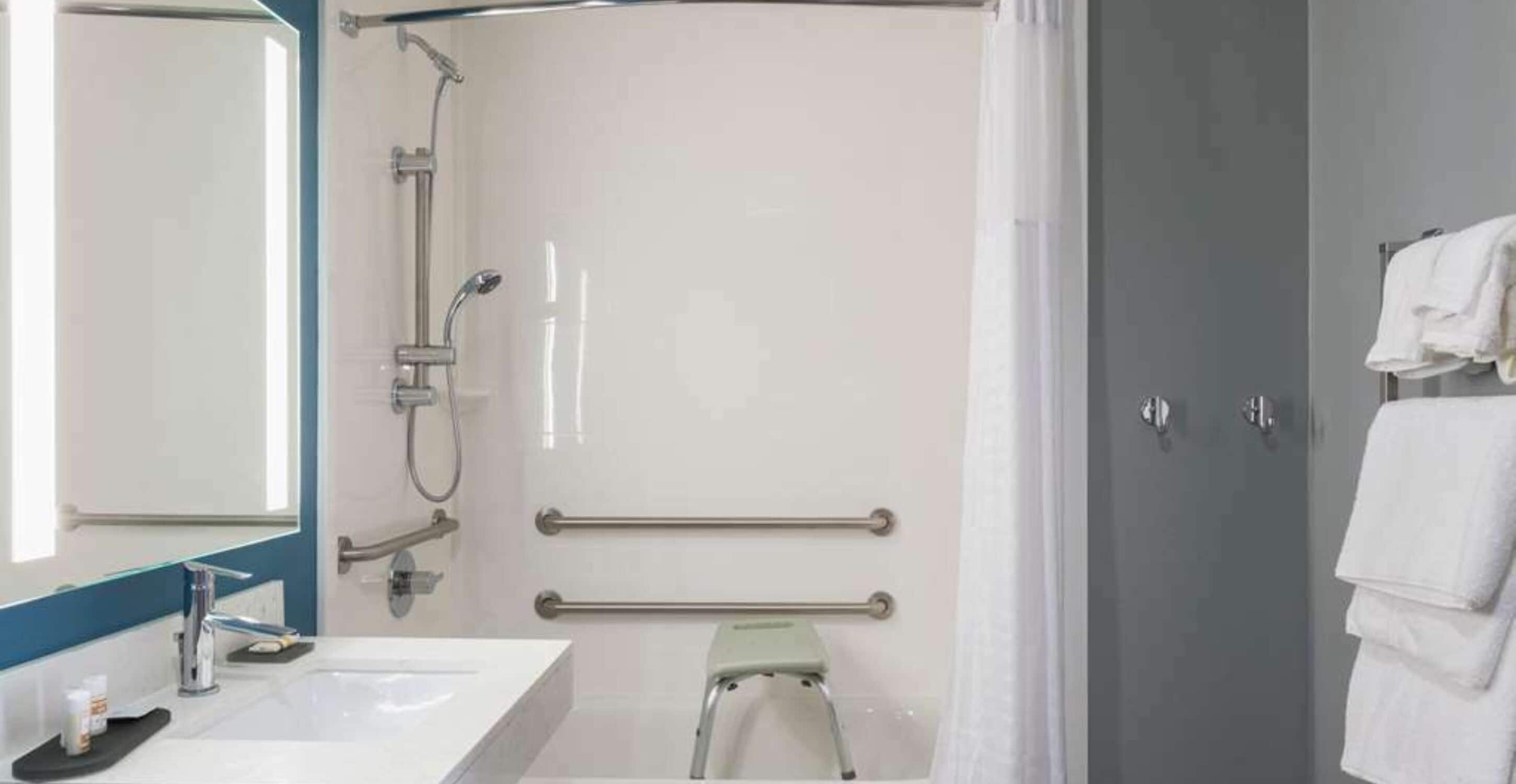 A modern bathroom with a shower, a sink, and a toilet.