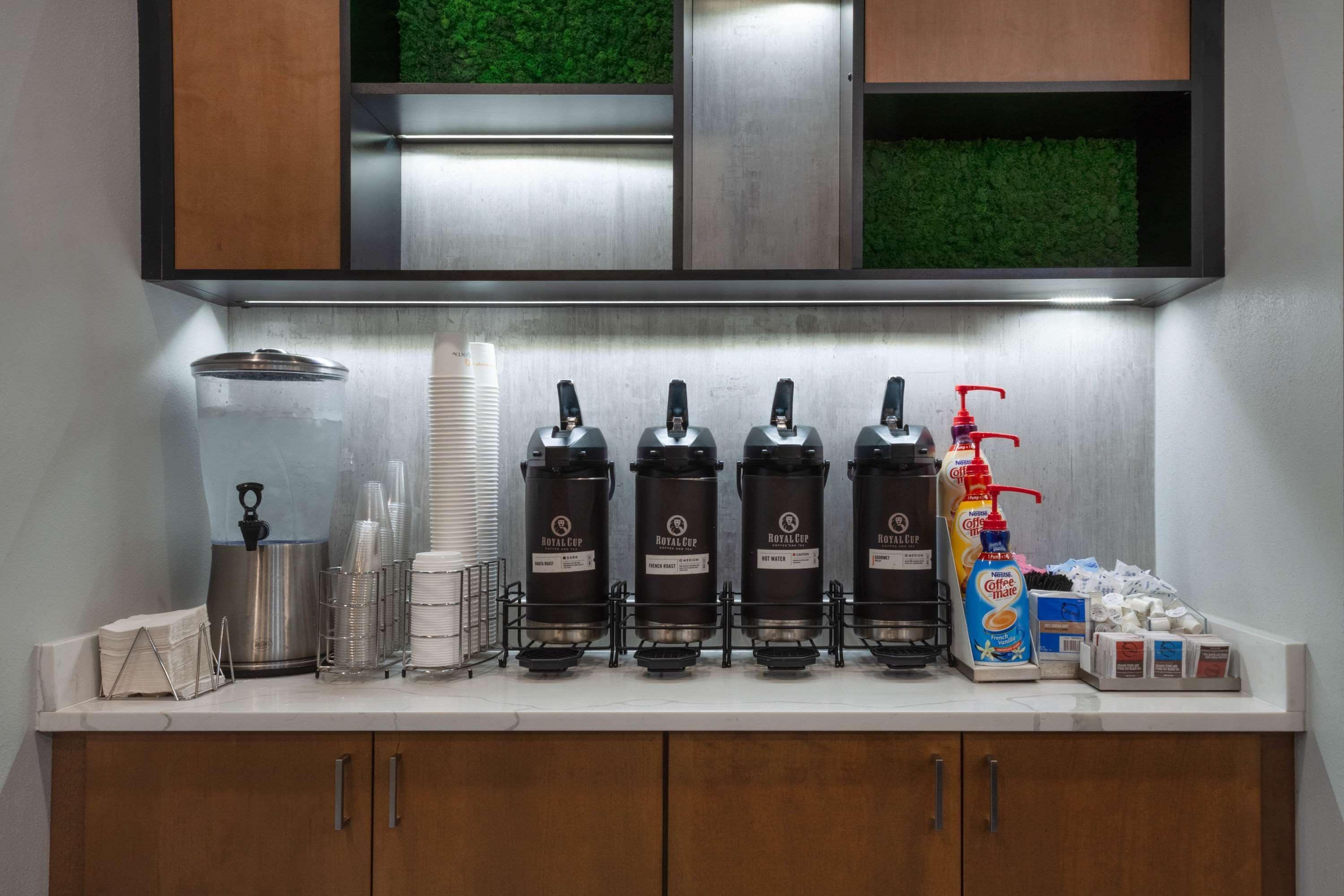 Angolo caffè con distributori multipli, macchina da caffè e montalatte.