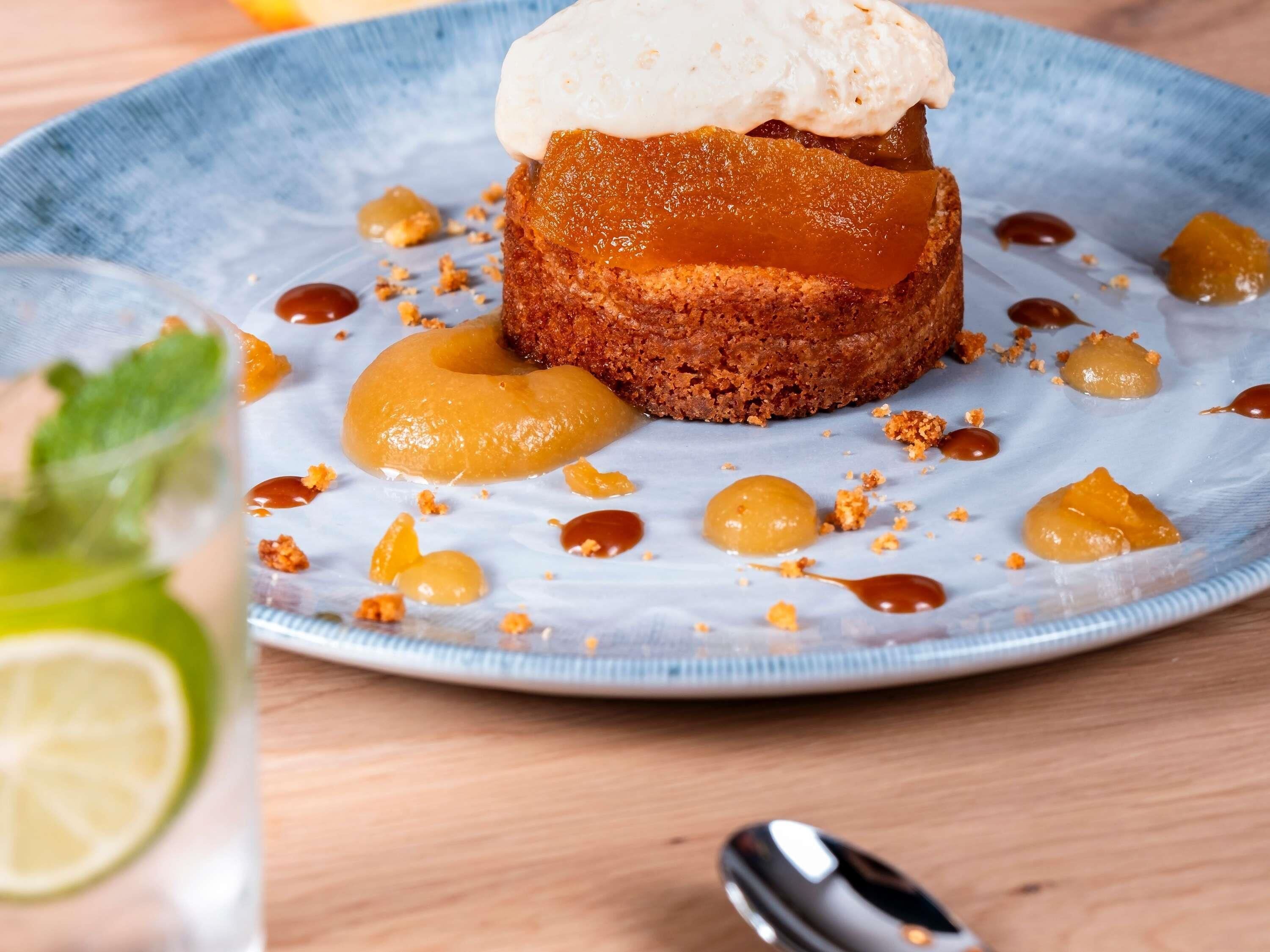 A dessert with caramel and a scoop of ice cream on a plate.