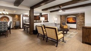 A spacious living area with a dining set, a sofa, and a fireplace. - Holiday Inn Club Vacations Scottsdale Resort by IHG (Scottsdale)