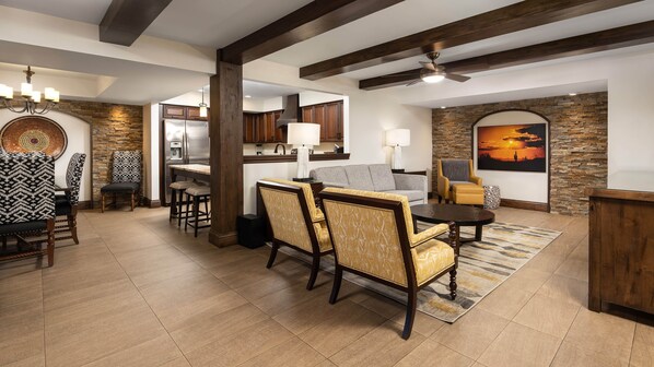 A spacious living area with a dining set, a sofa, and a fireplace. - Holiday Inn Club Vacations Scottsdale Resort by IHG (Scottsdale)