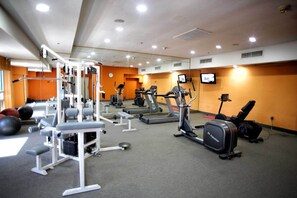 A gym with various exercise equipment, including treadmills, weight machines, and free weights. - Antaris Cintermex (Monterrey)