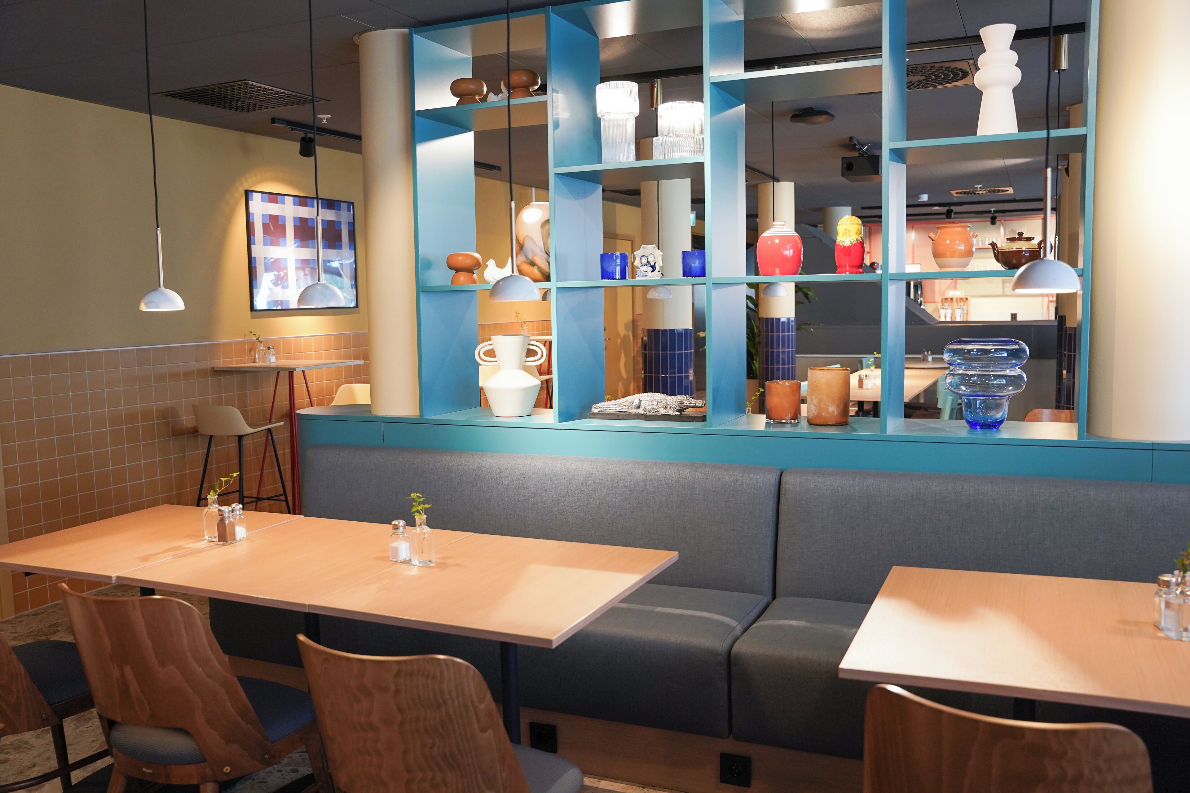 A restaurant interior with booths, tables, and a display of decorative items.