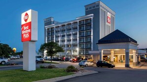 A Best Western Plus hotel with a modern design, multiple floors, and a well-lit entrance. - Best Western Plus Midwest Inn (Omaha)