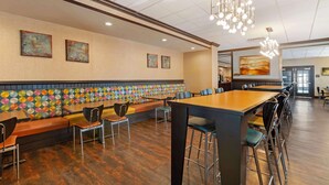 A restaurant with booths, high-top tables, and bar stools. - Best Western Plus Midwest Inn (Omaha)