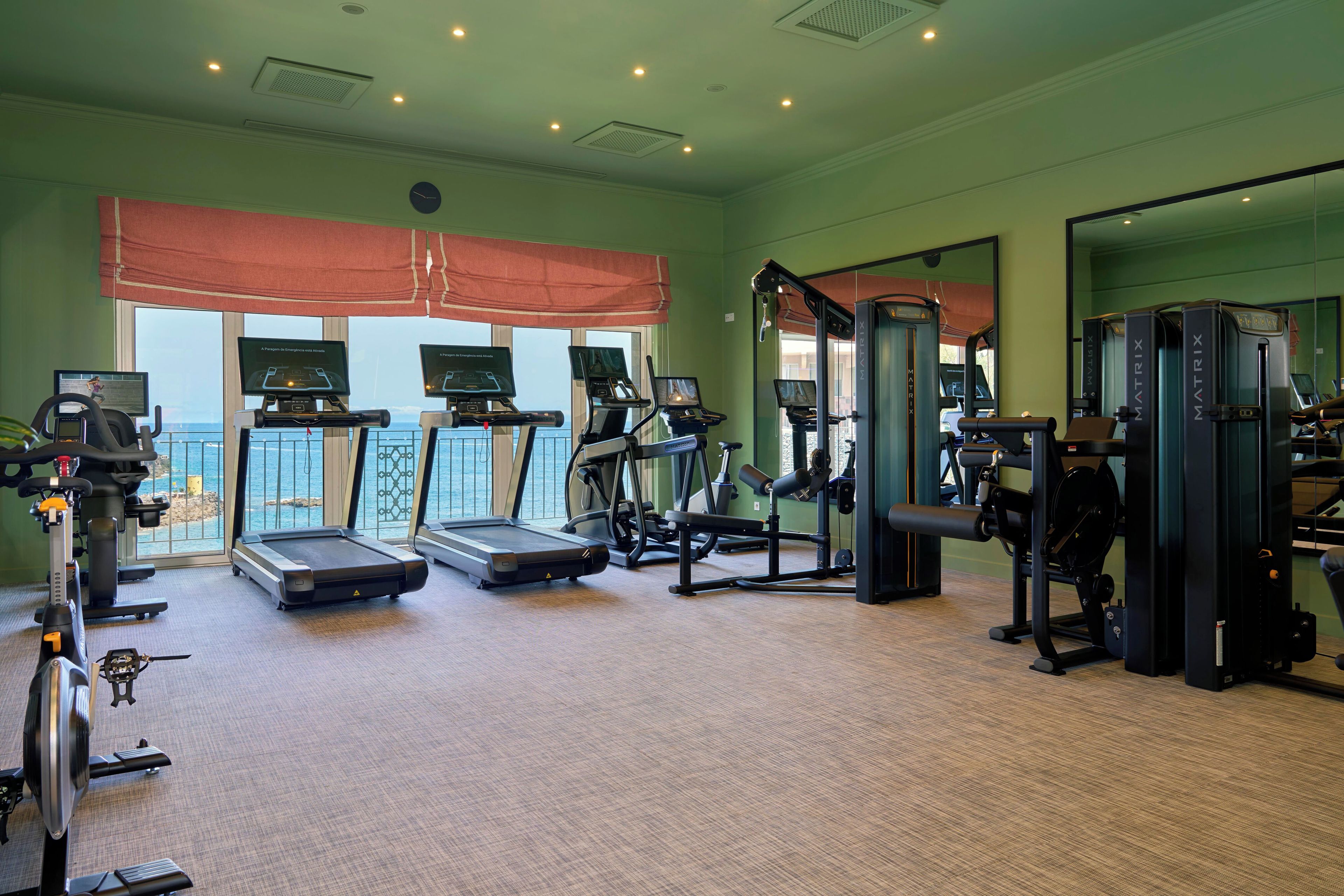 A gym with treadmills, weight machines, and exercise equipment.