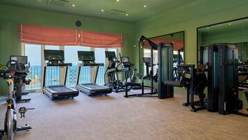 A gym with treadmills, weight machines, and exercise equipment.