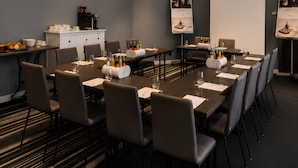 A conference room with a long table, chairs, a whiteboard, and a projector screen. - The Raphael Vienna Hotel, a member of Radisson Individuals Boutique (Vienna)
