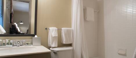 A bathroom with a sink, toilet, and bathtub.