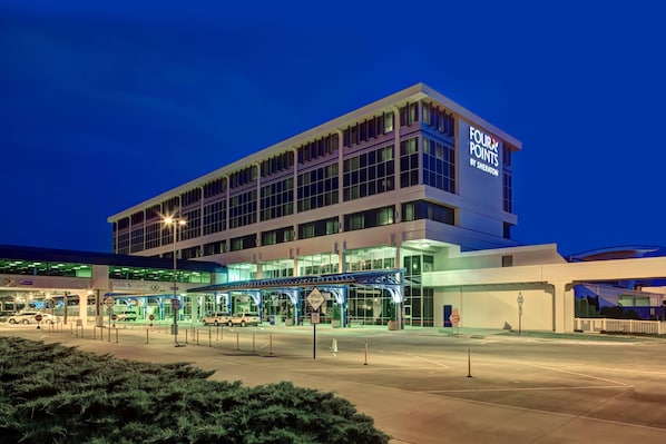 A modern hotel with a prominent sign reading "Four Points by Sheraton." - Four Points by Sheraton Huntsville Airport (Huntsville)