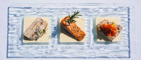 Three square dishes with different food items.