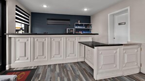 A kitchen with white cabinetry, a black countertop, and a herringbone-patterned floor. - Econo Lodge Inn & Suites Laredo - Nuevo Laredo (Laredo)