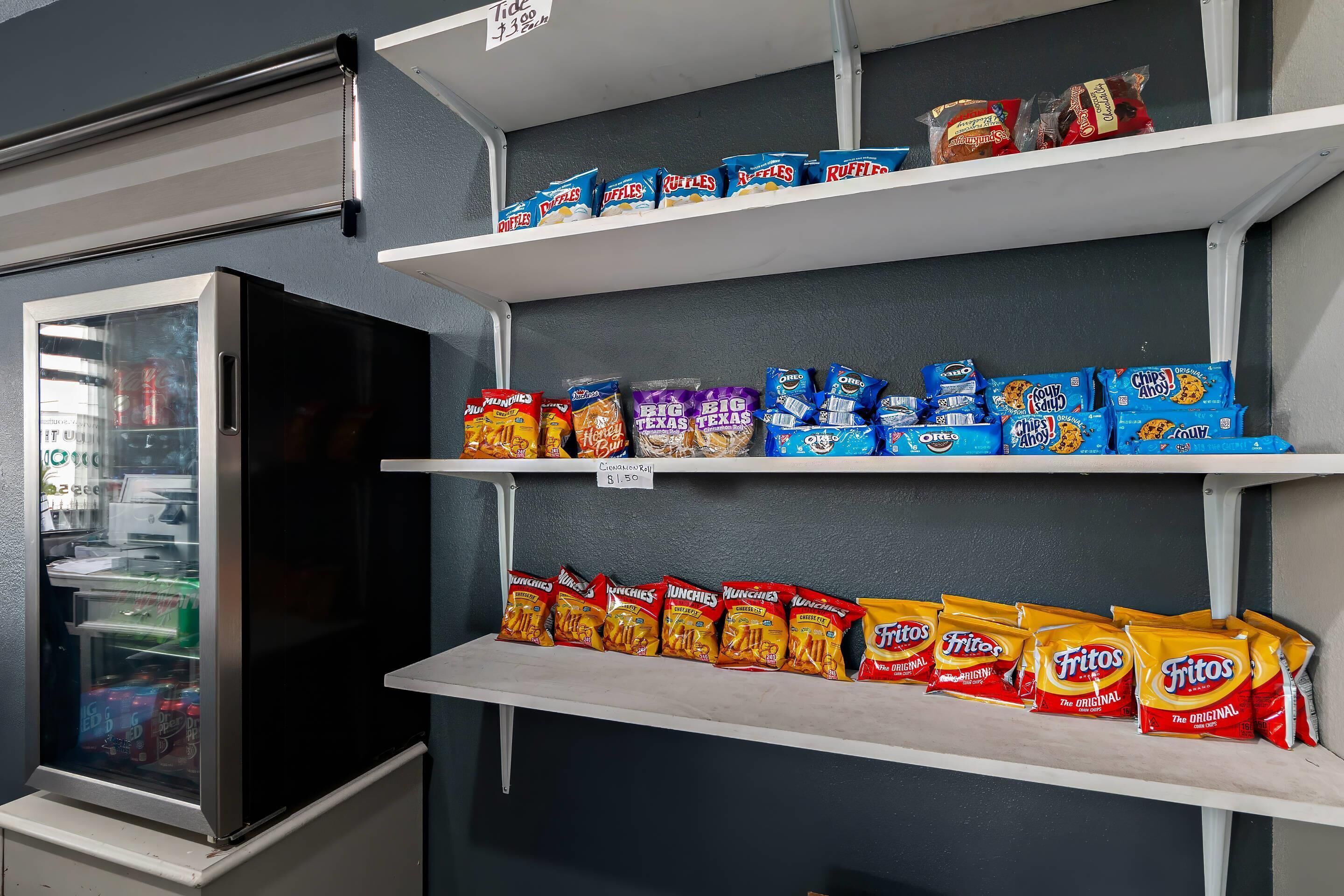 A snack display with various chips and cookies.