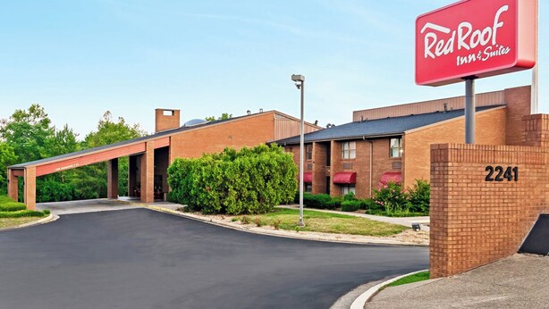 A Red Roof Inn & Suites building with a brick facade, numbered 2241, and a covered parking area. - Red Roof Inn & Suites Lexington - Hamburg (Lexington)