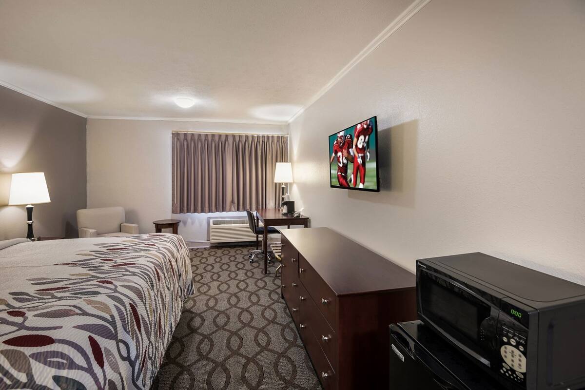 Desk, laptop workspace, blackout drapes, iron/ironing board