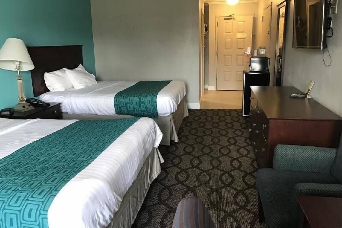 Desk, laptop workspace, blackout drapes, iron/ironing board