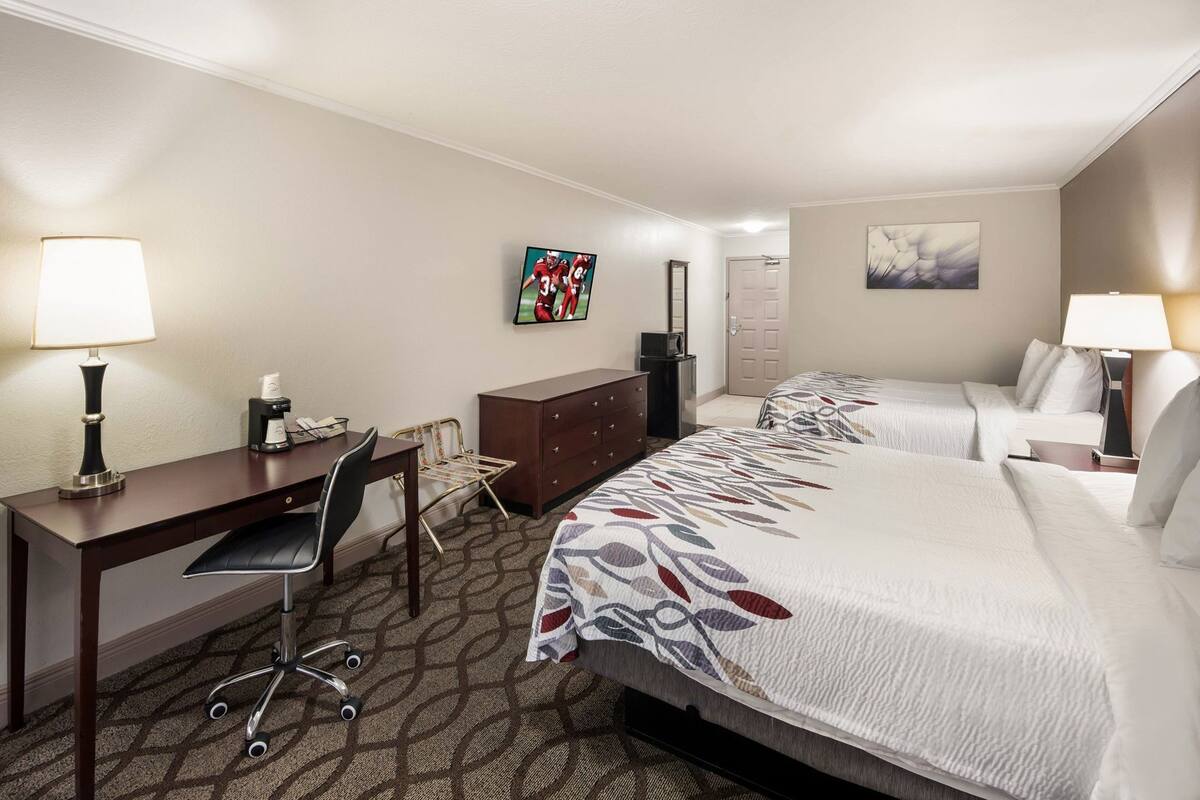 Desk, laptop workspace, blackout drapes, iron/ironing board