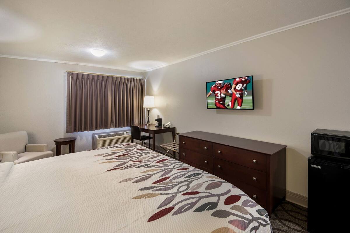 Desk, laptop workspace, blackout drapes, iron/ironing board