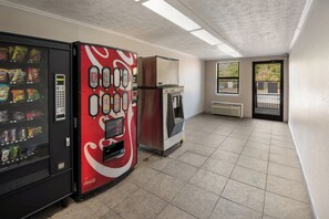 Un distributeur automatique proposant divers en-cas et un autre distributeur arborant la marque Coca-Cola.